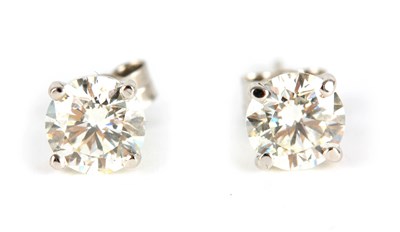 Lot 242 - A PAIR OF LADIES SOLITAIRE DIAMOND EARRINGS...