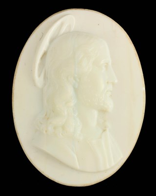 Lot 601 - AN EARLY CARVED OPAQUE GLASS OVAL PORTRAIT OF...