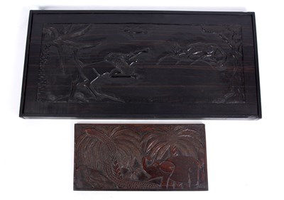 Lot 701 - A CARVED AFRICAN HARDWOOD PANEL depicting a...