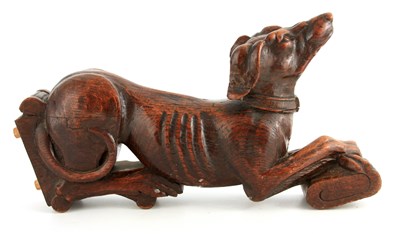 Lot 664 - A 19TH CENTURY CARVED OAK HERALDIC GREYHOUND...