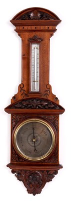 Lot 656 - A LATE 19TH CENTURY WALNUT ANEROID BAROMETER...