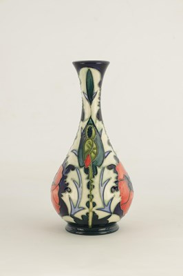 Lot 183 - A WILLIAM MOORCROFT FOOTED BULBOUS VASE WITH...