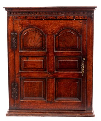 Lot 757 - AN UNUSUAL JOINED OAK HANGING CUPBOARD with...