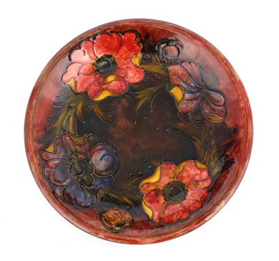 Lot 28 - A WILLIAM MOORCROFT SHALLOW DISH tube lined...