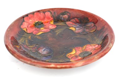 Lot 28 - A WILLIAM MOORCROFT SHALLOW DISH tube lined...