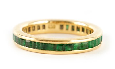 Lot 344 - AN 18CT GOLD AND EMERALD ETERNITY RING set all...