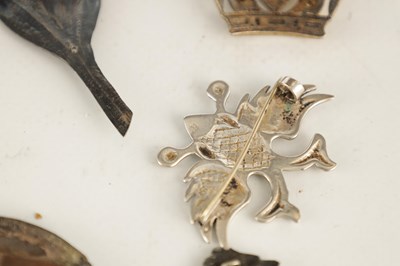 Lot 384 - A SELECTION OF SOLID SILVER BADGES AND MOUNTS...