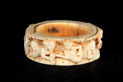 Lot 423 - A 17TH/18TH CENTURY INDIAN CARVED IVORY BANGLE...