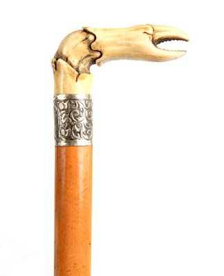 Lot 546 - A 19TH CENTURY CARVED BONE AND MALACCA WALKING...