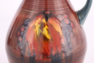 Lot 56 - A MOORCROFT OVOID TAPERING JUG WITH OGEE NECK...