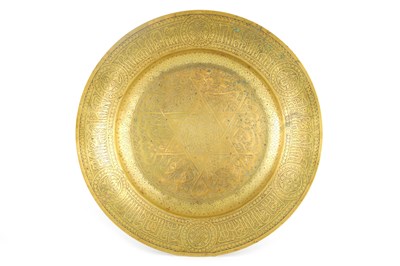 Lot 576 - A 19TH CENTURY ISLAMIC BRASS CHARGER with...