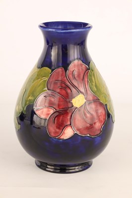 Lot 71 - A WALTER MOORCROFT FOOTED OVOID VASE decorated...