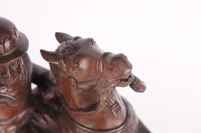 Lot 105 - A CHINESE CARVED HARDWOOD FIGURE OF A GENERAL ON HORSE BACK