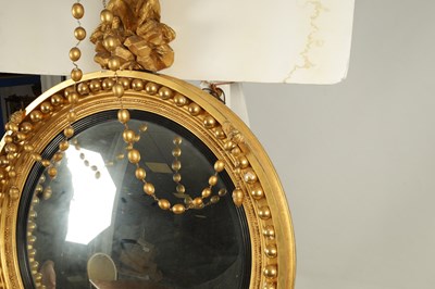 Lot 1026 - A REGENCY CARVED GILTWOOD CONVEX MIRROR OF LARGE SIZE