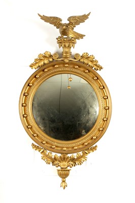 Lot 1094 - A REGENCY CARVED GILTWOOD CONVEX MIRROR