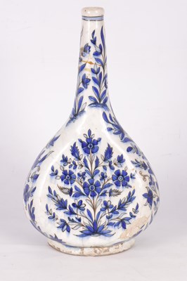 Lot 168 - AN EARLY EASTERN/PERSIAN BLUE AND WHITE EARTHENWARE SLENDER NECK VASE