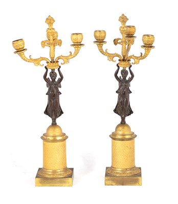 Lot 600 - A PAIR OF REGENCY FIGURAL BRONZE AND ORMOLU CANDELABRA