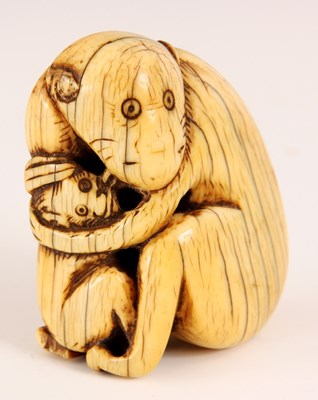 Lot 88 - AN IVORY NETSUKE IN THE FORM OF A MONKEY...