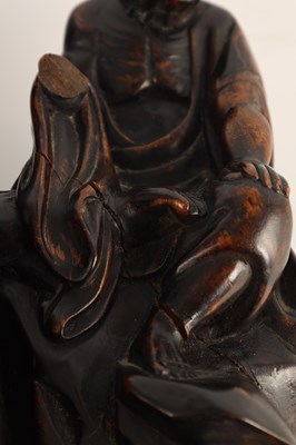Lot 75 - AN EARLY CHINESE CARVED HEAVY HARDWOOD FIGURAL SCULPTURE