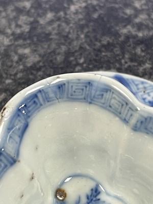 Lot 215 - AN 18TH CENTURY CHINESE KANGXI BLUE AND WHITE SHAPED CUP AND SAUCER