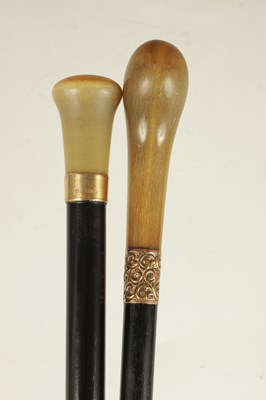 Lot 391 - TWO 19TH CENTURY RHINOCEROS HORN EBONISED WALKING STICKS