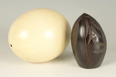 Lot 530 - A 19TH CENTURY CARVED COCONUT SHELL AND AN OSTRICH EGG