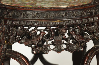 Lot 102 - A 19TH CENTURY CHINESE HARDWOOD GARDEN SEAT WITH CANTONESE PORCELAIN TOP