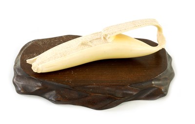 Lot 124 - A LATE 19TH CENTURY JAPANESE MEIJI PERIOD CARVED IVORY SCULPTURE OF A HALF PEELED BANANA