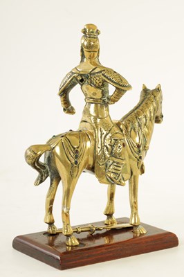 Lot 81 - AN EARLY PERIOD CHINESE CAST BRASS MODEL OF A KNIGHT ON HORSEBACK