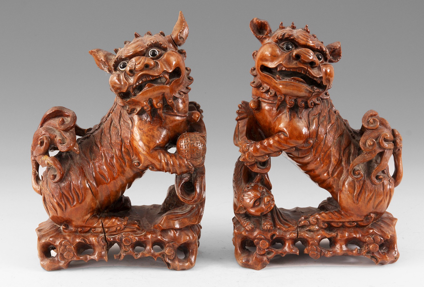Lot 179 A PAIR OF CHINESE CARVED HARDWOOD FOO DOGS