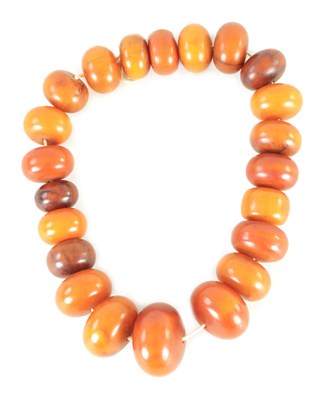 Lot 182 - A STRING OF UNUSUALLY LARGE GRADUATED AMBER BEADS
