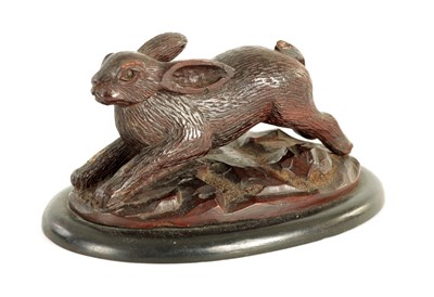 Lot 634 - A LATE 19TH CENTURY  BLACK FOREST CARVED SCULPTURE OF A RUNNING HARE