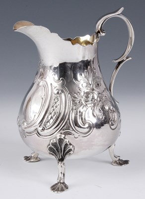 Lot 245 - A LATE 19TH CENTURY SILVER JUG embossed with...