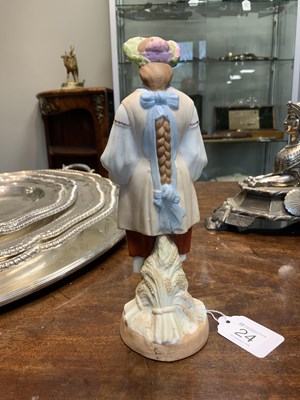 Lot 24 - AN EARLY 20TH CENTURY RUSSIAN STANDING BISQUE FIGURE OF A FLOWER GIRL