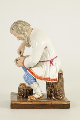 Lot 23 - AN EARLY 20TH CENTURY RUSSIAN PORCELAIN FIGURE DEPICTING A COBLER