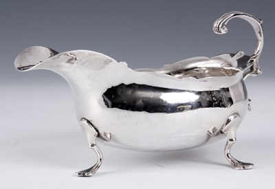 Lot 246 - A GEORGE III SILVER SAUCEBOAT of squat bulbous...
