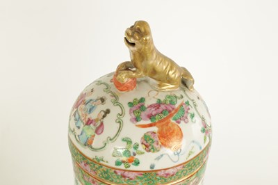 Lot 61 - A PAIR OF 19TH CENTURY CANTON OVOID VASES WITH DOME COVERS AND DOG O FOE FINIALS