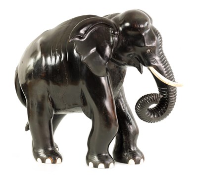 Lot 160 - A LARGE LATE 19TH CENTURY ANGLO-INDIAN CARVED EBONY ELEPHANT
