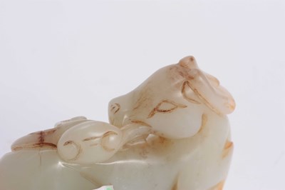 Lot 143 - A CHINESE GREEN RUSTED JADE SCULPTURE OF A HORSE