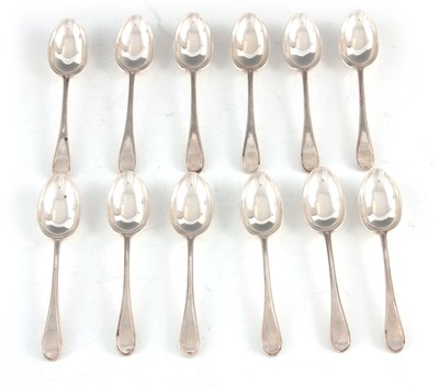 Lot 447 - A GEORGE V SET OF TWELVE DOUBLE STRUCK BEAD EDGE TEASPOONS