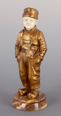 Lot 247 - A FRENCH ART DECO GILT BRONZE AND IVORY SCULPTURE OF A YOUNG DUTCH BOY BY JOSEPH D’ ASTE (1881 - 1945)