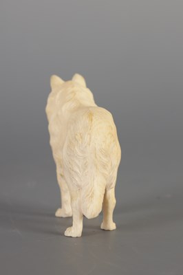 Lot 70 - A JAPANESE MEIJI PERIOD CARVED IVORY SCULPTURE OF A DOG