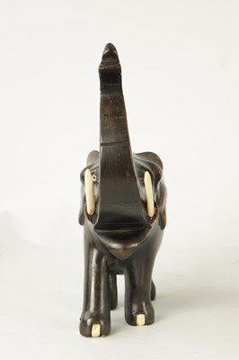 Lot 23 - A LATE 19TH CENTURY ANGLO INDIAN CARVED EBONY ELEPHANT
