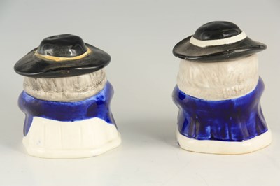 Lot 25 - A PAIR OF COLOURFUL SEATED TOBY FIGURE LIDDED JARS