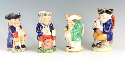Lot 104 - A GROUP OF THREE COLOURFUL SEATED STAFFORDSHIRE TOBY JUGS
