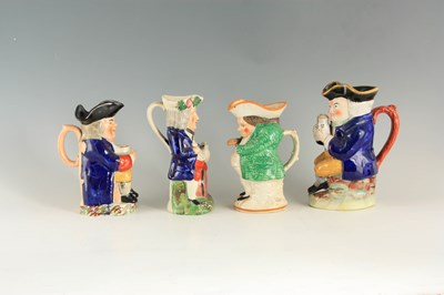 Lot 104 - A GROUP OF THREE COLOURFUL SEATED STAFFORDSHIRE TOBY JUGS