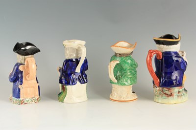 Lot 69 - A GROUP OF THREE COLOURFUL SEATED STAFFORDSHIRE TOBY JUGS