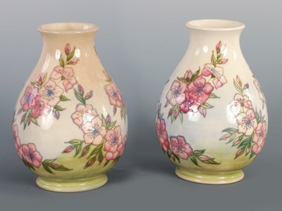 Lot 153 - A PAIR OF MOORCROFT SPRING BLOSSOM PATTERN BALUSTER SHAPED VASES