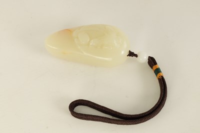 Lot 65 - A CHINESE CARVED JADE BOULDER DEPICTING A CROUCHING DRAGON