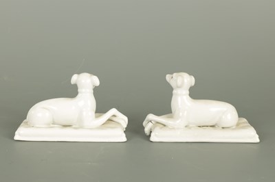 Lot 111 - A PAIR OF WHITE PORCELAIN FIGURES OF RECUMBENT HOUNDS